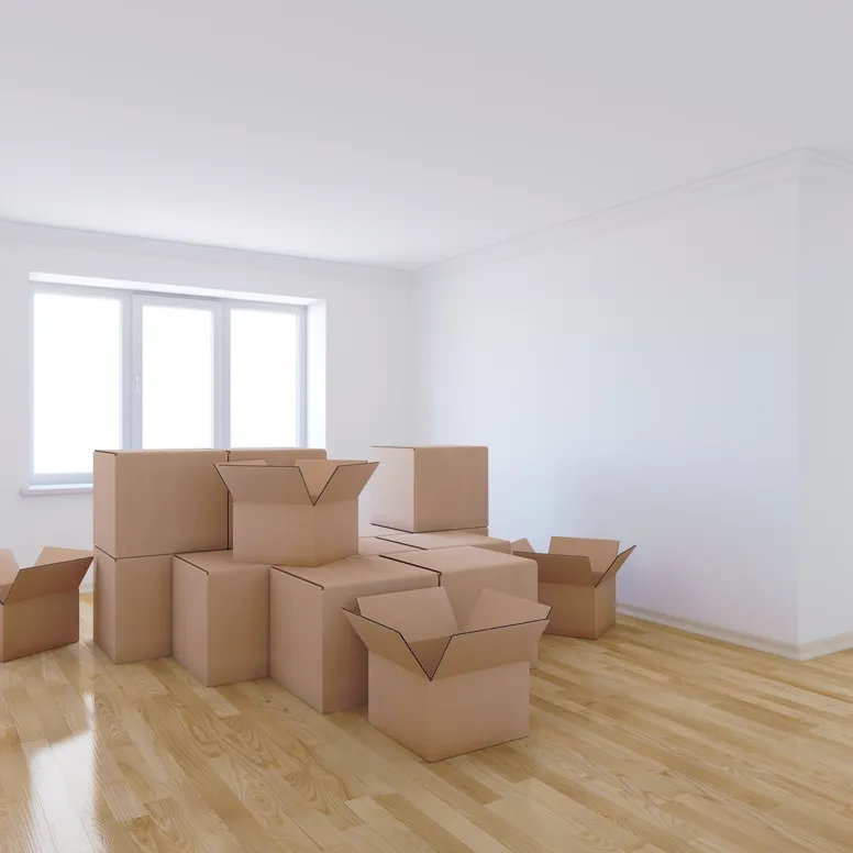 A number of moving boxes sit in an otherwise empty room.